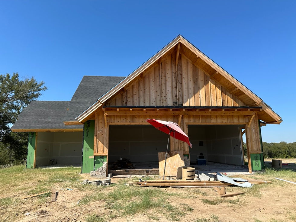 a red umbrella sits in front of a house under construction
