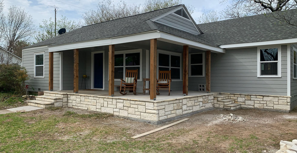 New rock skirt along the front of the house. Cedar columns on the front porch. 