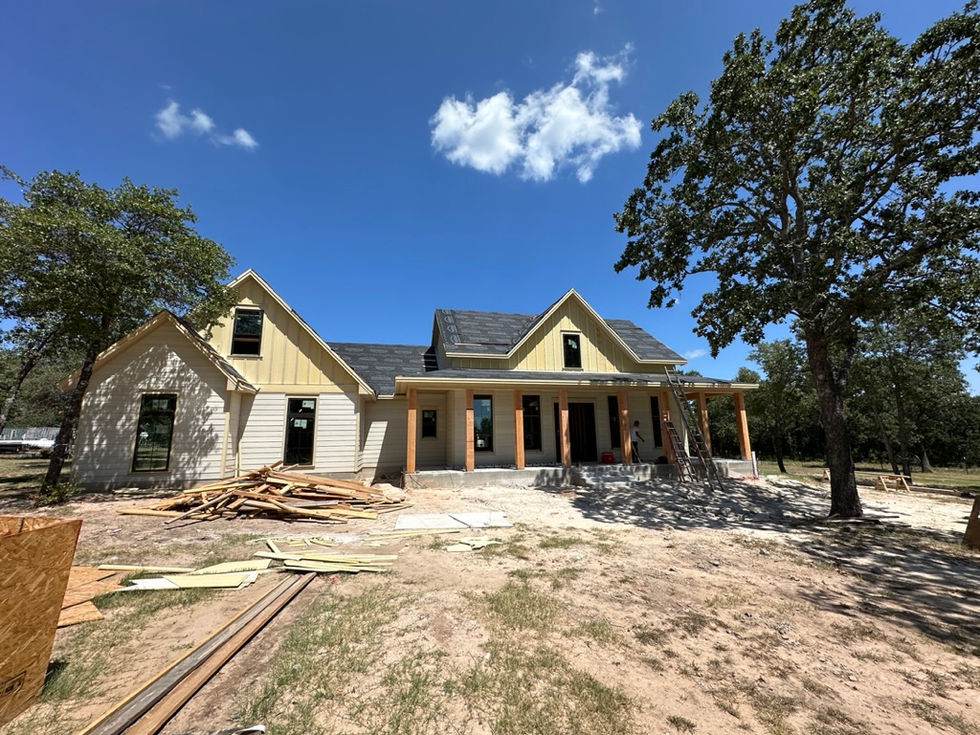 a house that is being built with a lot of wood in front of it