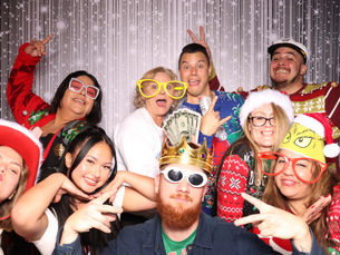 Employees enjoying the photo booth at their Holiday Party