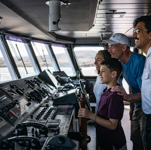 Students learning with expedition naturalist onboard small expedition ship
