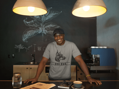 Man wearing Doberman dog dad tshirt in front of chalk board