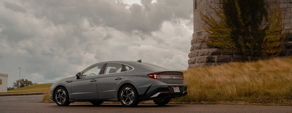 Hyundai Sonata rear 3/4 view with a lot of clouds