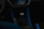 Subaru WRX tS interior showing a manual gear stick with shift pattern, surrounded by blue detailing. Above, a digital display shows climate controls.