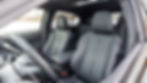 Interior of a car with black leather seats, steering wheel, and sunroof. Snowy landscape is visible through the windows, creating a calm mood. Mitsubishi Eclipse Cross