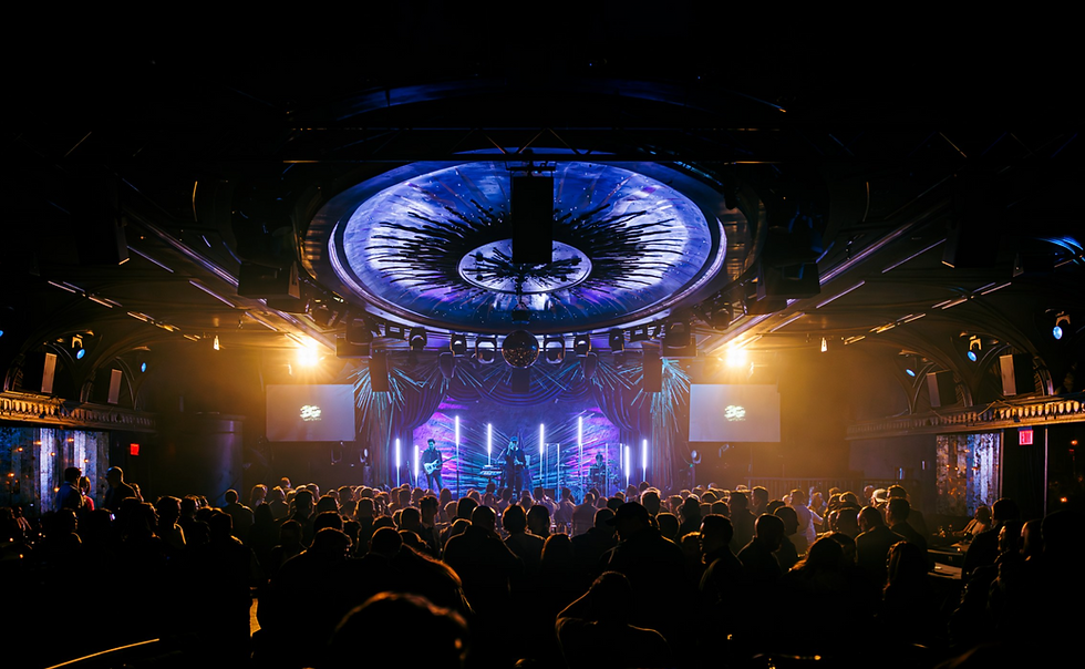 audience enjoying live concert captured by corporate event videography team, Raised Media Co