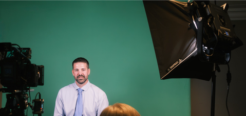 Behind-the-scenes corporate headshot session with green backdrop – Raised Media Co