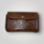 The front view of a rectangular hand tooled, dyed, and stitched phone holster with a front snap, and matching straps that wrap around the horn of a saddle.