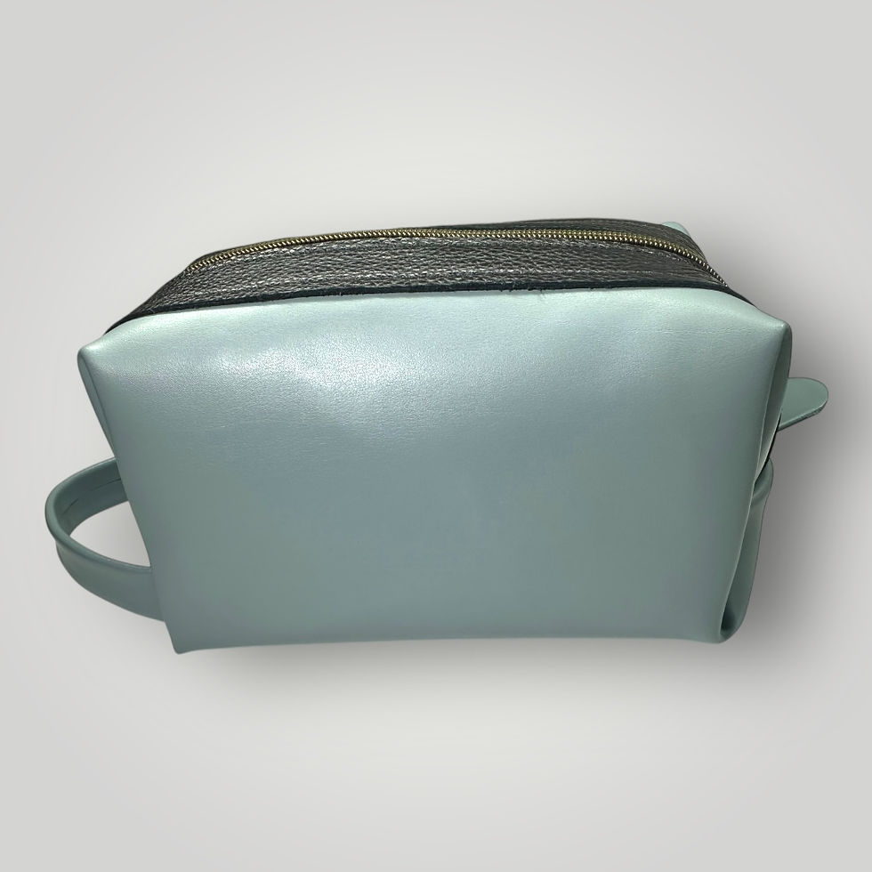 Thumbnail: A side view of a dusty blue Italian leather travel case with black leather accents and black zipper.