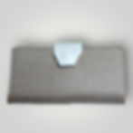 The front side of a handmade Italian leather long wallet with a metallic check pattern and a white leather snap closure.