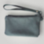 A supple black leather rectangular coin purse with a matching wrist strap.
