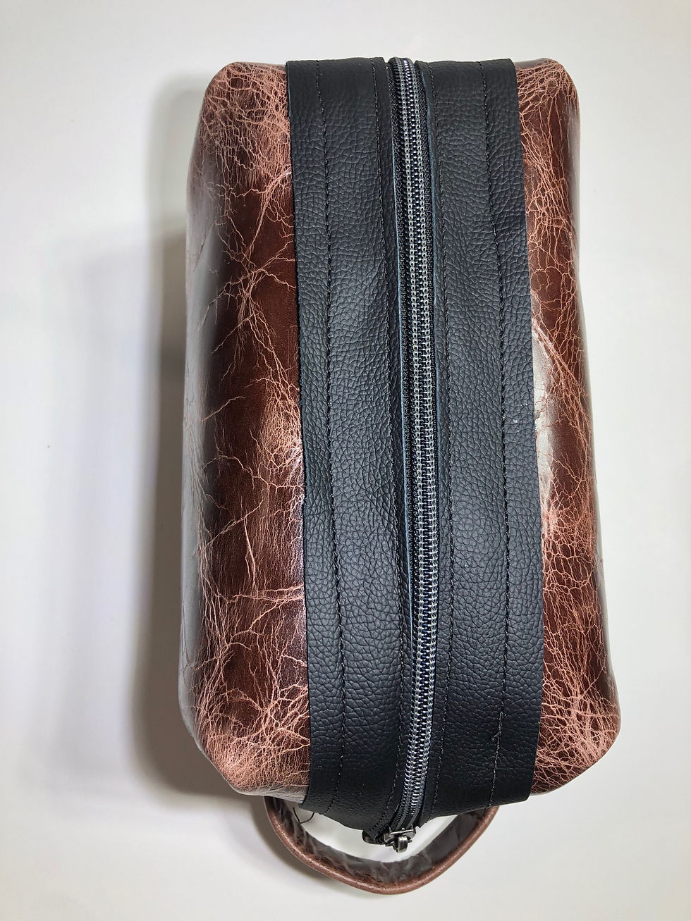 Thumbnail: Brown pull-up leather shaving bag.