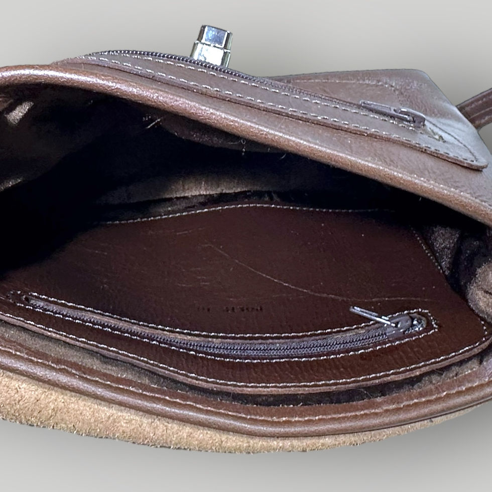 Thumbnail: The inside pocket view of a handmade brown leather shoulder bag with a silver clasp enclosure on the front.