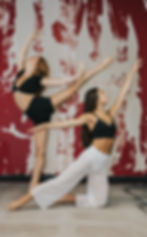 Two dancers where passion meets purpose in a studio pose.
