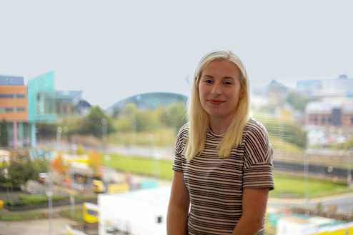 Headshot of woman in front of a window