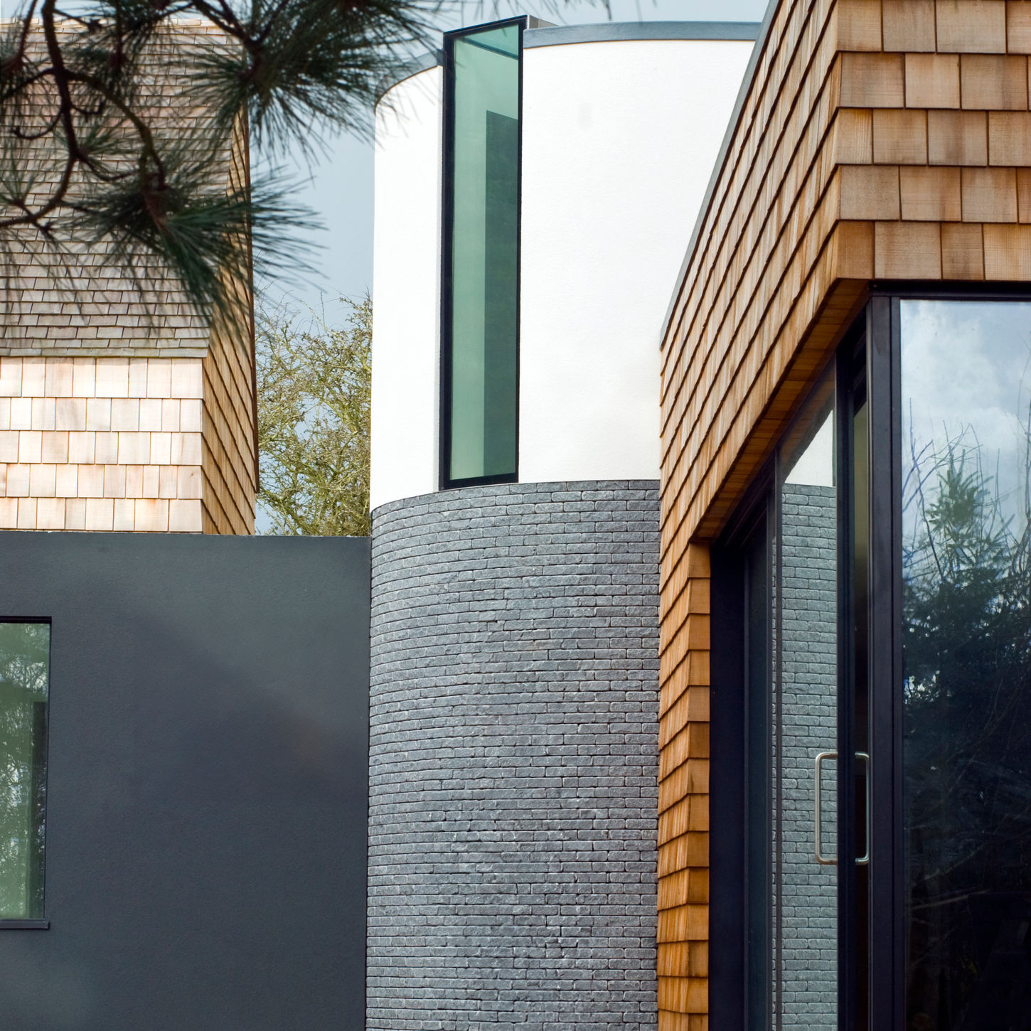 Jamie Falla’s Les Bardeaux, Guernsey—L-shaped rural home wrapping around sheltered courtyard garden