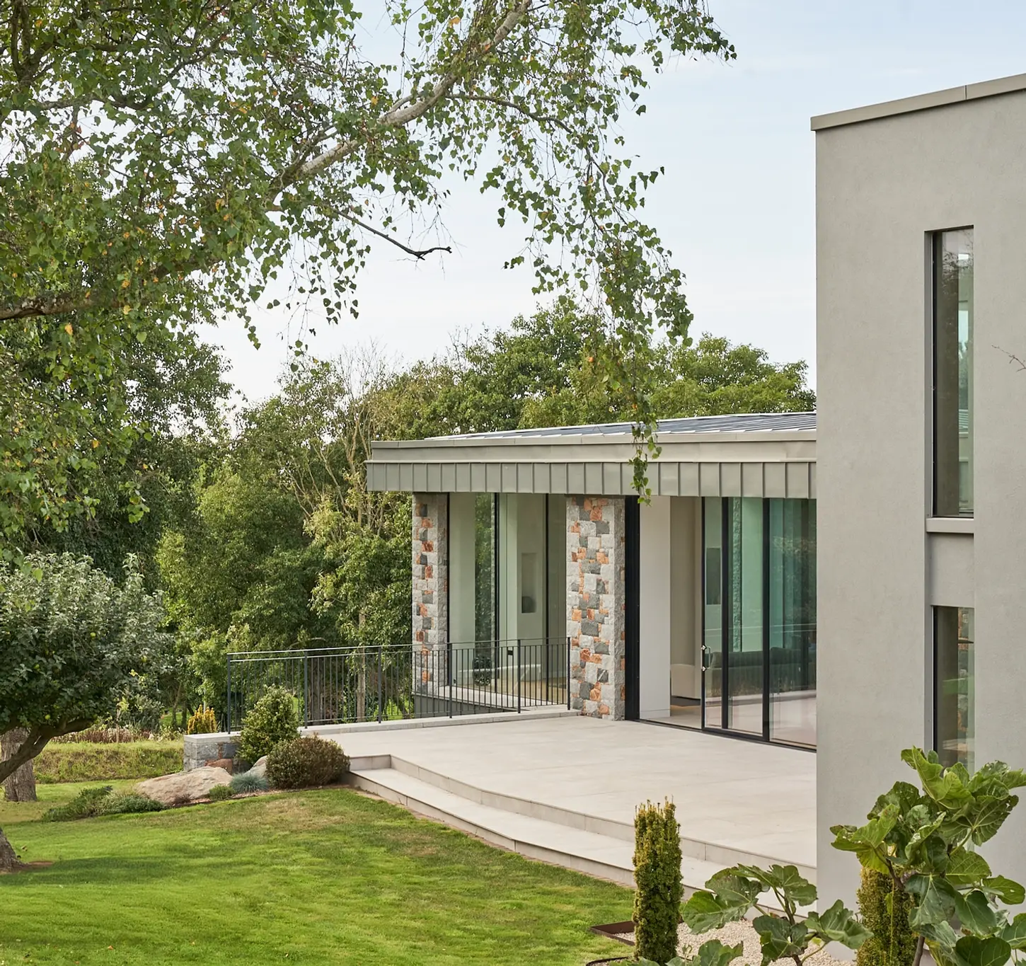 AI House by Jamie Falla, Guernsey—three granite and zinc volumes quietly rooted in coastal tradition and daily ritual