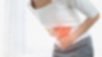 A woman holding her stomach in pain