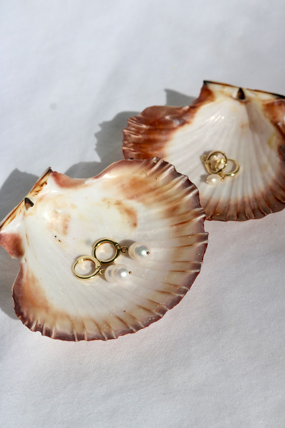 Minimalist pearl hoops.