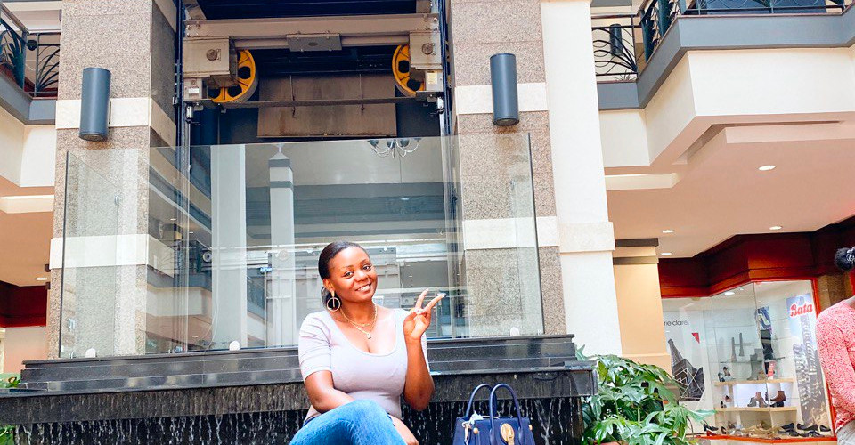 Image of a lady sitting in front of a fountain at Gallerra shopping center in Nairobi, Kenya