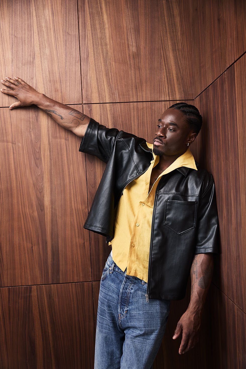 A man leaning against a wall