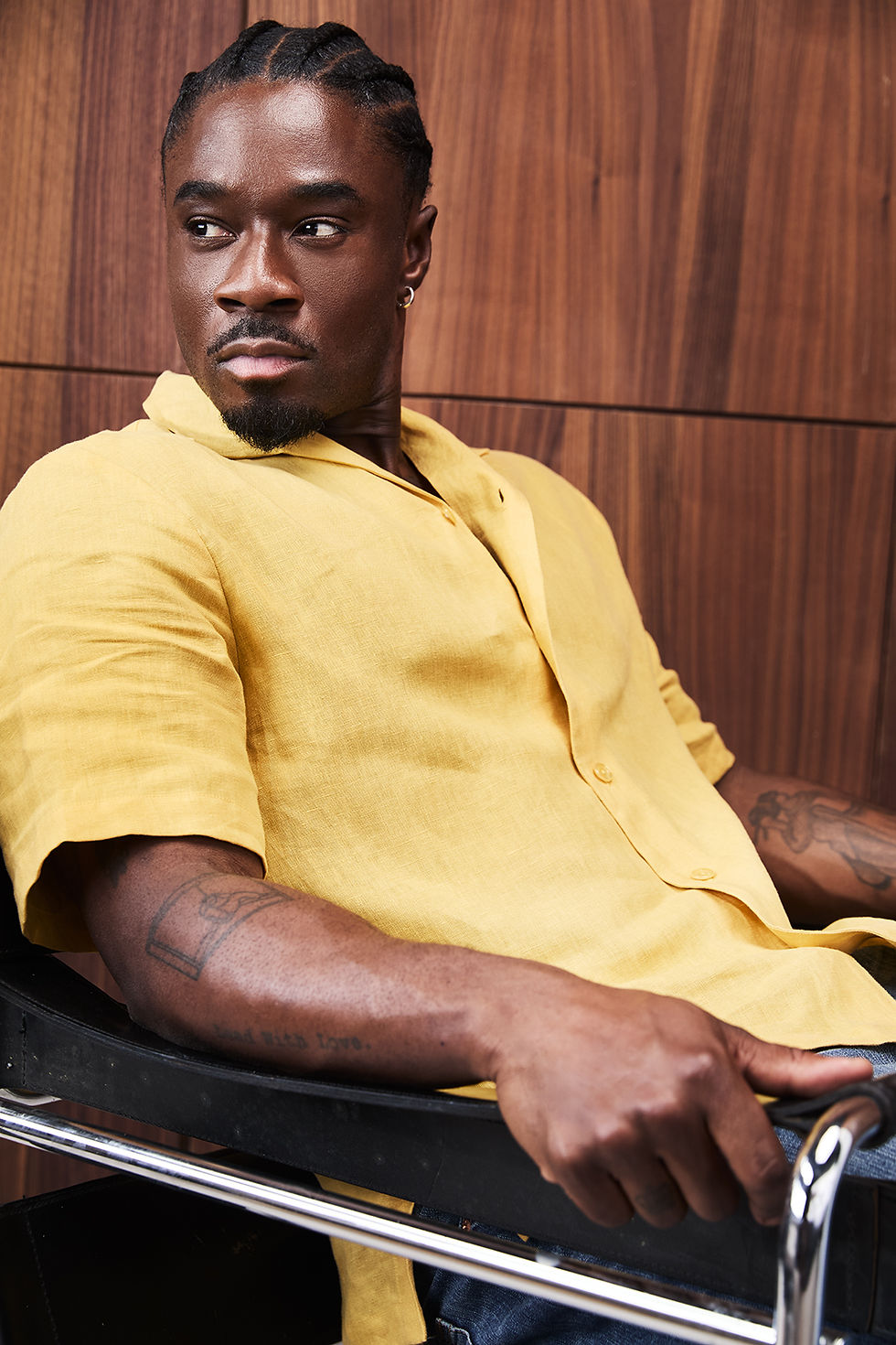 A man facing towards the camera on a chair