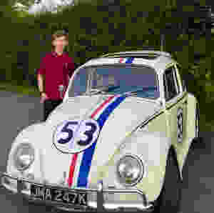 Daniel stood by a white car with red,blue and white stripes and the number 53 on the front