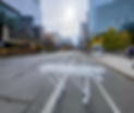 A white gurney stands on an empty road with the sun shining down through clouds.