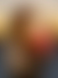 Model in streetwear cap and gold jacket holding Glow Watermelon Blush gummy to the sun, golden hour cannabis photography Maryland