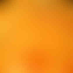 Extreme macro shot of golden cannabis concentrate with a glistening, orange segment-like texture