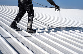 Metal roof painting Technician performing painting of roof in white color Work at height R