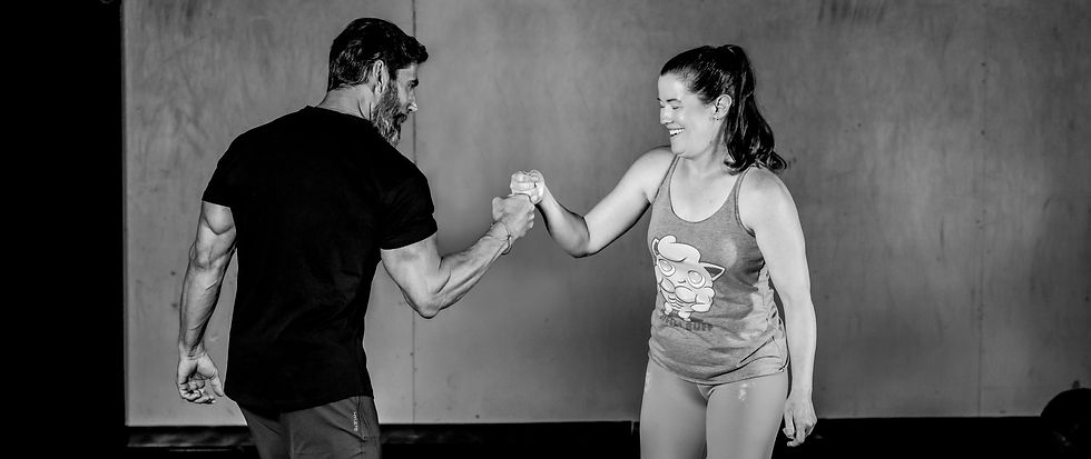 personal trainer and client fist bump