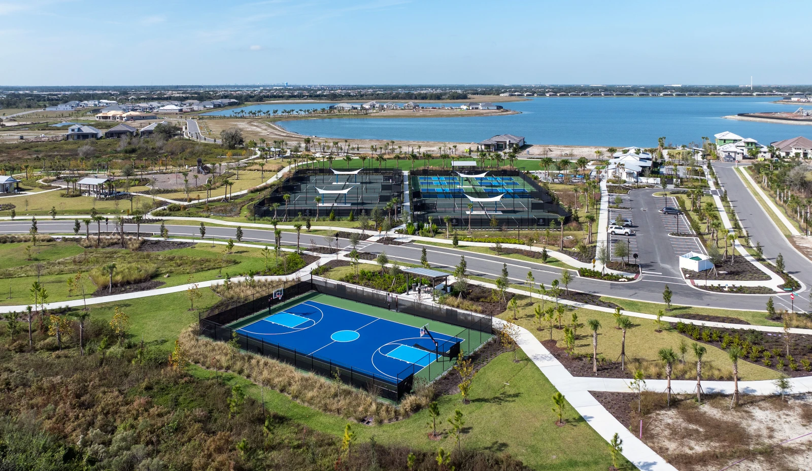 Aerial view of a tropical, luxury resort with pickleball courts.