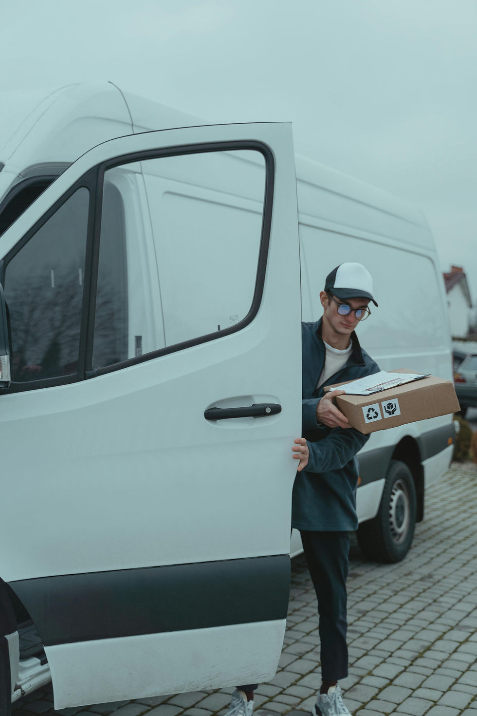 Delivery person exiting van with package