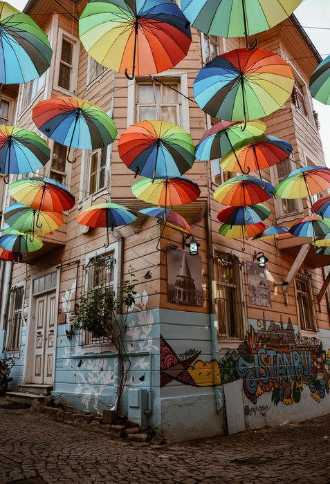Colorful umbrellas above building, street art, VoyageVista