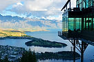 Stunning Queenstown lake and mountain vista from a glass-walled building