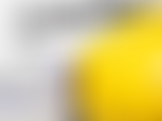 Rolled construction plans and a yellow hard hat placed beside a building permit document, representing the cost and approval process for construction projects in the Hamptons.