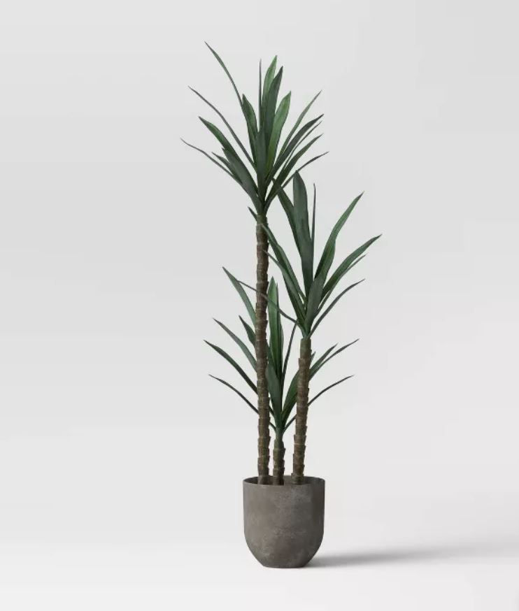 faux Dracaena plant in gray cement concrete planter