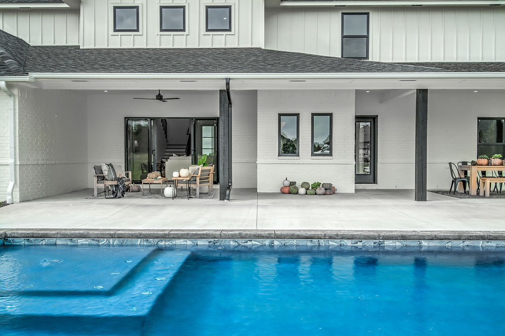 House of Rad Black and White Modern Farmhouse Exterior Oklahoma City Bushel Baskets Mums Pumpkins Lanterns Back Porch Decor Fall Porch Decor Modern Pool Rectangle Pool