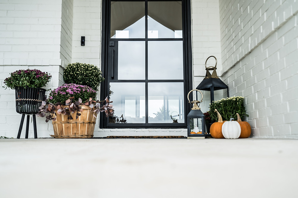 House of Rad Black and White Modern Farmhouse Exterior Oklahoma City Bushel Baskets Mums Pumpkins Lanterns Front Porch Decor Fall Porch Decor