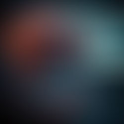 A large brain with glowing veins is connected to a keyboard and screen, with wires in a dimly lit, high-tech setting.