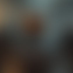 A futuristic robot with glowing orange eyes stands in a dimly lit industrial setting, covered in water droplets, exuding a mysterious mood.