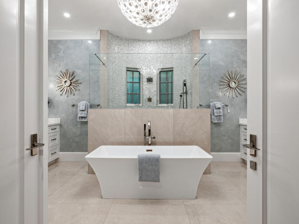 Elegant bathroom with soaking tub and decorative tile feature wall