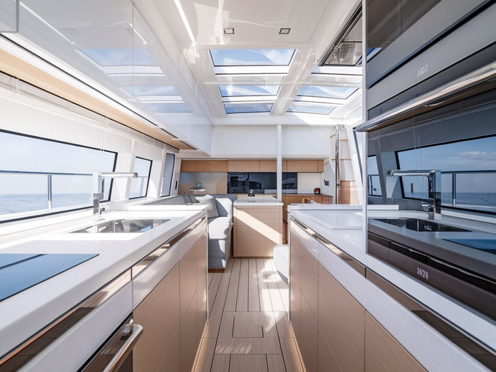 Luxury yacht kitchen with wooden finishes, sleek cabinetry, and panoramic windows