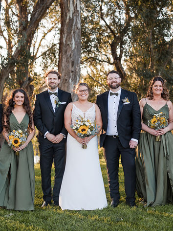 Bride and groom posing with their bridal party in the gardens at Lazy River Estate Dubbo NSW.