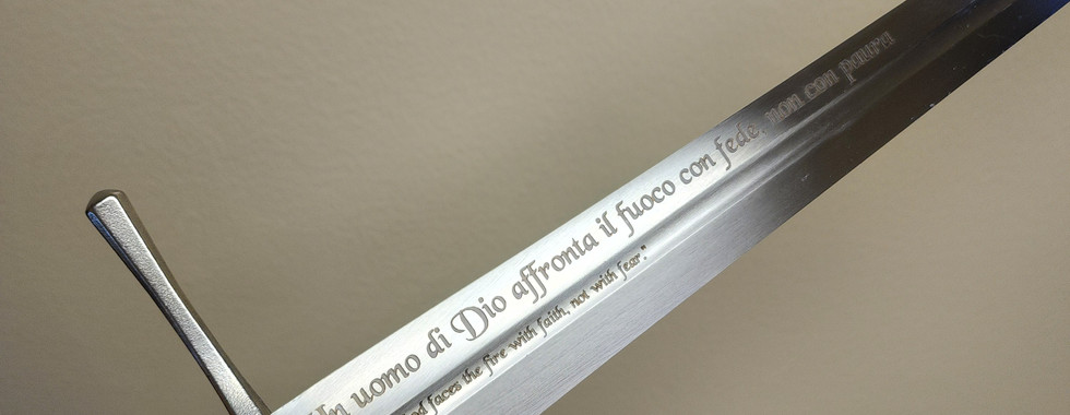 A laser engraved sword with Latin words engraved on it