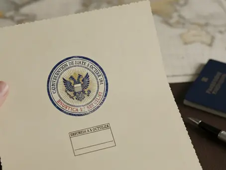 Hand holding document with Apostille of The Hague stamp, symbolizing international legal recognition.