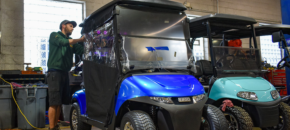 a repairman from Michigan Golf Carts encloses an EZGO golf cart