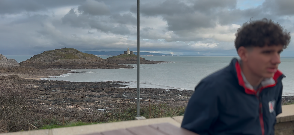 Cameron with the stunning view of Bracelet Bay as the backdrop