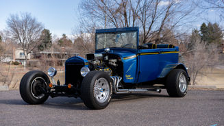 blue ford t-bucket 1990/1923 hot rod parked outside  